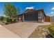 Charming single-story home with a two-car garage, desert landscaping, and a brick paver driveway at 31219 N 6Th Pl, Phoenix, AZ 85085