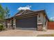 Charming single-story home with a two-car garage, desert landscaping, and a brick paver driveway at 31219 N 6Th Pl, Phoenix, AZ 85085