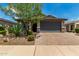 Charming single-story home with a two-car garage, desert landscaping, and a brick paver driveway at 31219 N 6Th Pl, Phoenix, AZ 85085
