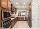 Modern kitchen featuring stainless steel appliances, granite countertops, and wood cabinets at 31219 N 6Th Pl, Phoenix, AZ 85085