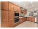 Spacious kitchen featuring wood cabinets, stainless steel appliances, granite countertops, and recessed lighting at 31219 N 6Th Pl, Phoenix, AZ 85085