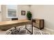 Home office with a wooden desk, patterned rug, and natural light, creating an inspiring workspace at 31219 N 6Th Pl, Phoenix, AZ 85085