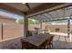 Outdoor patio with brick paving, a built-in grill, and a dining table for entertaining with seating for six at 31219 N 6Th Pl, Phoenix, AZ 85085