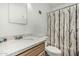 Bright bathroom features a granite countertop vanity and a toilet with a decorative shower curtain at 3208 W Wagoner Rd, Phoenix, AZ 85053
