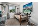 Cozy bedroom features a daybed, window with curtains, exercise bike and decorative Taj Mahal wall art at 3208 W Wagoner Rd, Phoenix, AZ 85053