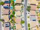 An aerial view showing a neighborhood with neatly arranged homes, some featuring solar panels and private pools at 3511 W Allens Peak Dr, San Tan Valley, AZ 85144