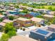 An aerial view of a suburban community with a mix of single-Gathering homes, some with solar panels and landscaped yards at 3511 W Allens Peak Dr, San Tan Valley, AZ 85144