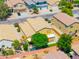 An aerial view showcases a neighborhood with well-maintained homes, lush greenery, and orderly street layout at 3511 W Allens Peak Dr, San Tan Valley, AZ 85144