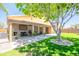Spacious backyard with covered patio, mature tree, and manicured lawn perfect for outdoor living at 3511 W Allens Peak Dr, San Tan Valley, AZ 85144