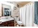 Bathroom featuring a marble vanity, framed mirror, and a shower curtain, combining style and functionality at 3511 W Allens Peak Dr, San Tan Valley, AZ 85144