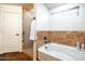 Bright bathroom featuring a bathtub and shower with tile surround at 3511 W Allens Peak Dr, San Tan Valley, AZ 85144