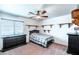 Cozy bedroom with dark furniture, wooden shelves, and a window with blinds, creating a peaceful retreat at 3511 W Allens Peak Dr, San Tan Valley, AZ 85144
