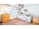 Bright bedroom features a ceiling fan and a large window, complemented by a cozy daybed at 3511 W Allens Peak Dr, San Tan Valley, AZ 85144