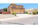 Welcoming two-story home with a three-car garage, neat landscaping, and paved driveway at 3511 W Allens Peak Dr, San Tan Valley, AZ 85144