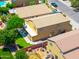An aerial view features a home with a well-manicured lawn and backyard play area in a residential neighborhood at 3511 W Allens Peak Dr, San Tan Valley, AZ 85144