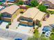 Exterior shot of a two-story home with a three-car garage, desert landscaping, and neutral color scheme at 3511 W Allens Peak Dr, San Tan Valley, AZ 85144