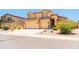 Inviting home with a three-car garage and tasteful landscaping enhances curb appeal at 3511 W Allens Peak Dr, San Tan Valley, AZ 85144