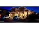 Inviting two-story home featuring manicured landscaping, warm exterior lighting, and a multi-car garage with ample driveway space at 3511 W Allens Peak Dr, San Tan Valley, AZ 85144