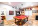 Inviting game room with pool table, arcade machine, and views to the bathroom, perfect for entertaining guests at 3511 W Allens Peak Dr, San Tan Valley, AZ 85144