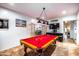 Entertaining game room with pool table, TV, and lounge space, perfect for gatherings and leisure activities at 3511 W Allens Peak Dr, San Tan Valley, AZ 85144