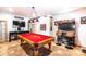 Well-lit game room featuring a pool table, arcade game, and bar seating, designed for fun and relaxation at 3511 W Allens Peak Dr, San Tan Valley, AZ 85144
