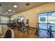 Well-equipped fitness center with treadmills, stationary bikes, and large windows for natural light at 3511 W Allens Peak Dr, San Tan Valley, AZ 85144