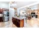 Bright, open-concept kitchen seamlessly connects to dining and living areas, featuring cherry wood cabinetry and a central island at 3511 W Allens Peak Dr, San Tan Valley, AZ 85144