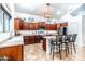 Well-lit kitchen features a central island, stainless steel appliances, plenty of counterspace, and cherry wood cabinets at 3511 W Allens Peak Dr, San Tan Valley, AZ 85144