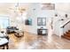 Bright living room boasts high ceilings, tile floors, and a view of the staircase at 3511 W Allens Peak Dr, San Tan Valley, AZ 85144