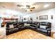 Spacious living room with comfortable leather sofa, neutral walls and floors and open access to the kitchen at 3511 W Allens Peak Dr, San Tan Valley, AZ 85144
