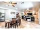 Open-concept living space with dining area, featuring tile floors, and a comfortable leather sofa in the adjacent living room at 3511 W Allens Peak Dr, San Tan Valley, AZ 85144