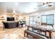 Open-concept living space with dining area, featuring tile floors, and a comfortable leather sofa in the adjacent living room at 3511 W Allens Peak Dr, San Tan Valley, AZ 85144