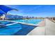 A large community pool with shade structures and lounging areas, perfect for summer relaxation at 3511 W Allens Peak Dr, San Tan Valley, AZ 85144