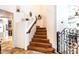 Bright foyer featuring a wood staircase with decorative objects on the landing at 3511 W Allens Peak Dr, San Tan Valley, AZ 85144