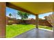 The backyard featuring artificial grass, desert landscaping, and a covered patio at 37911 N Luke Ln, San Tan Valley, AZ 85140