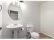 Powder room features a pedestal sink, toilet, and neutral tile floors at 37911 N Luke Ln, San Tan Valley, AZ 85140