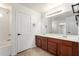 Bathroom with tub and shower, double sinks, and wooden vanity at 37911 N Luke Ln, San Tan Valley, AZ 85140