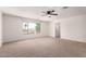 Large bedroom with neutral carpet, ceiling fan, and an ensuite bathroom at 37911 N Luke Ln, San Tan Valley, AZ 85140