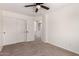 Bedroom featuring carpet, a ceiling fan, and doors to the closet and access to other rooms at 37911 N Luke Ln, San Tan Valley, AZ 85140
