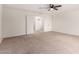 Large bedroom with neutral carpet, ceiling fan, and open doorframe at 37911 N Luke Ln, San Tan Valley, AZ 85140