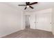 Bedroom featuring carpet, a ceiling fan, and doors to the closet and access to other rooms at 37911 N Luke Ln, San Tan Valley, AZ 85140