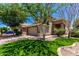 Charming home featuring well-manicured lawn, mature trees, and a two-car garage at 37911 N Luke Ln, San Tan Valley, AZ 85140