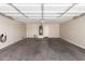 Spacious garage with room for multiple vehicles, a garage door and a wall mounted electric charger at 37911 N Luke Ln, San Tan Valley, AZ 85140