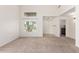 Bright, neutral living room with high ceilings, large window, and soft carpeting at 37911 N Luke Ln, San Tan Valley, AZ 85140