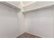 Spacious walk-in closet with white walls, shelving and a hanging rod for optimal storage capacity at 37911 N Luke Ln, San Tan Valley, AZ 85140