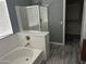 Bathroom featuring a tub and shower combination, with white tiled walls and modern fixtures at 38242 N Armadillo Dr, San Tan Valley, AZ 85140