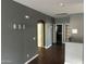 Hallway with hardwood floors and gray walls, creating a bright and airy space at 38242 N Armadillo Dr, San Tan Valley, AZ 85140