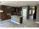 Spacious kitchen featuring an island with sink, stainless appliances, and gray tile flooring at 38242 N Armadillo Dr, San Tan Valley, AZ 85140