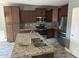 Modern kitchen with stainless steel appliances, granite countertops, and stylish dark wood cabinets at 38242 N Armadillo Dr, San Tan Valley, AZ 85140