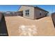 Backyard view of the house with block wall and covered patio awaiting your personal touch at 3845 N Camden Dr, Florence, AZ 85132